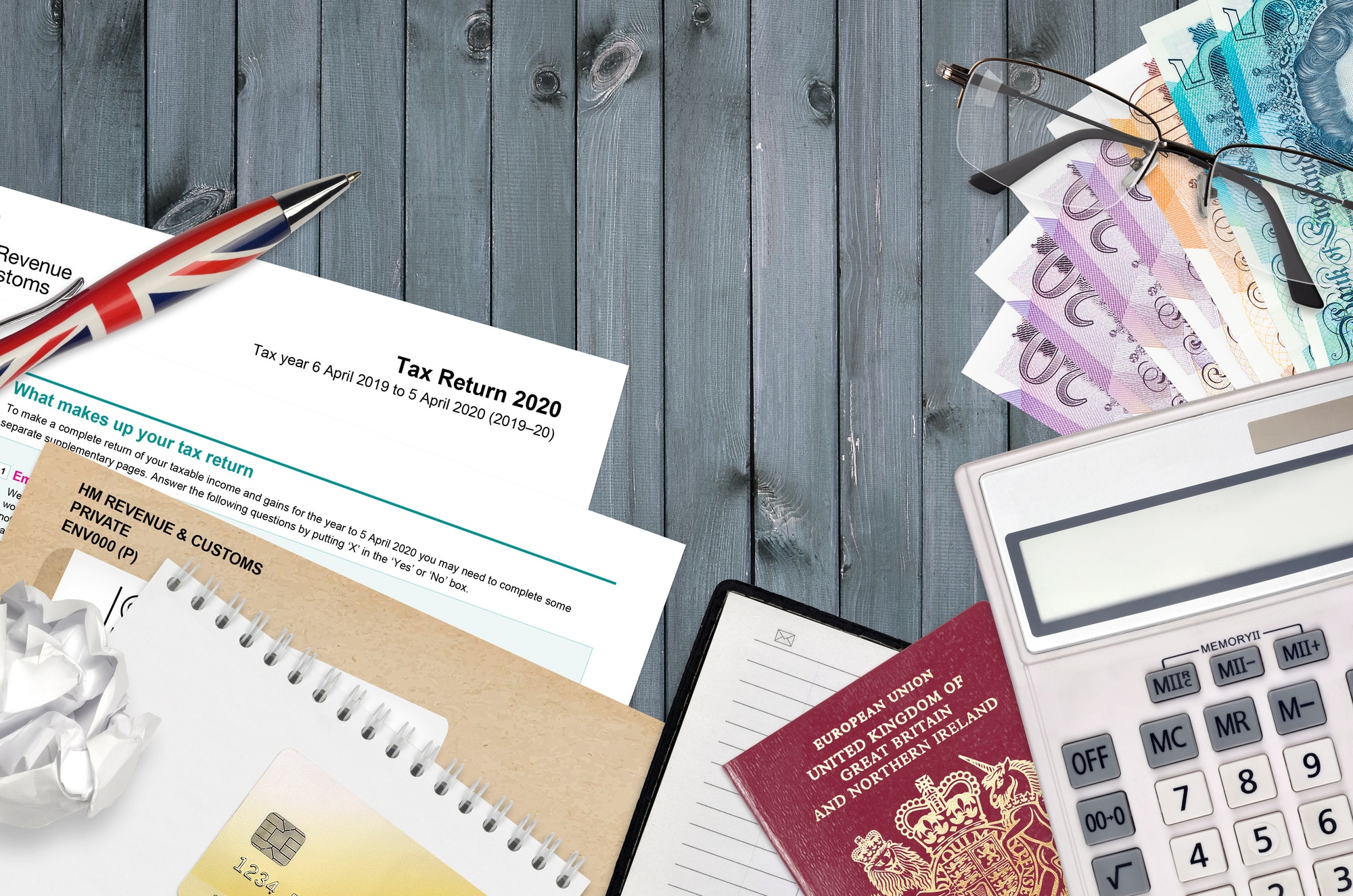 English form sa100 Tax return by HM revenue and customs lies on table with office items